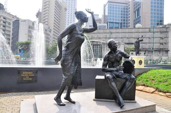 Two Portraits: The Statue in Lagos and the Woman in the Records